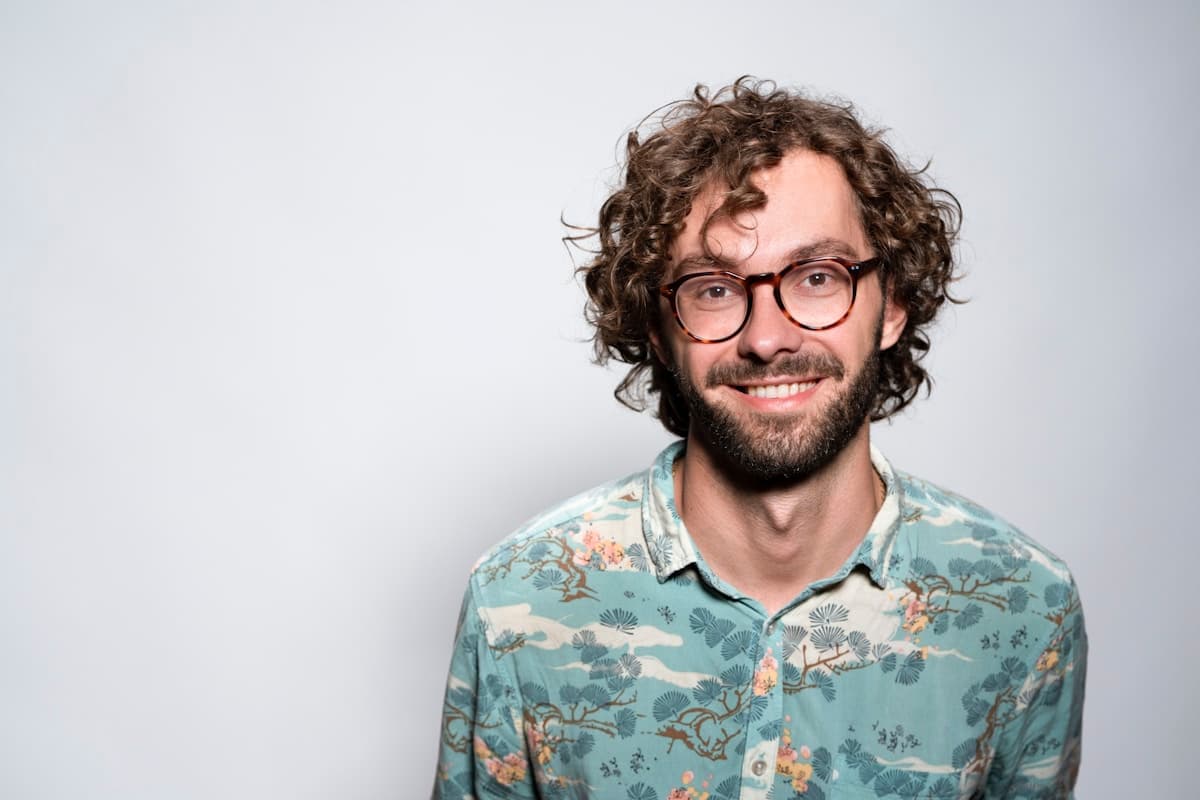 Smiling man shown in an illustrative skincare check-in portrait.